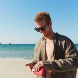 Man using sunscreen lotion SPF 50 by We are Feel Good Inc
