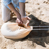 filling the sand bag of a beach tent