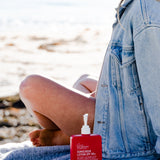 Woman with Sunscreen lotion SPF 50 by We are Feel Good Inc