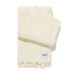 folded family beach blanket in natural
