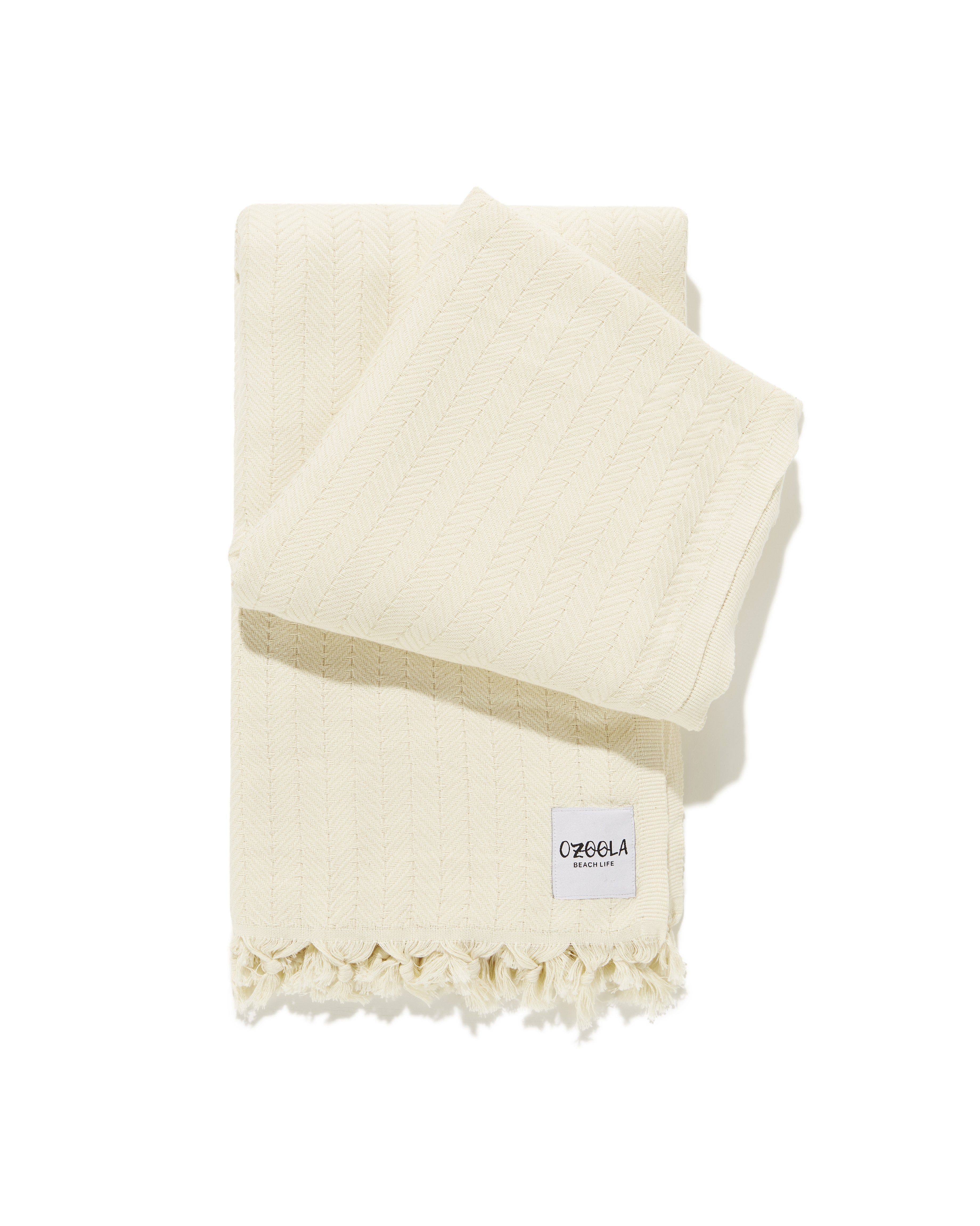 folded family beach blanket in natural