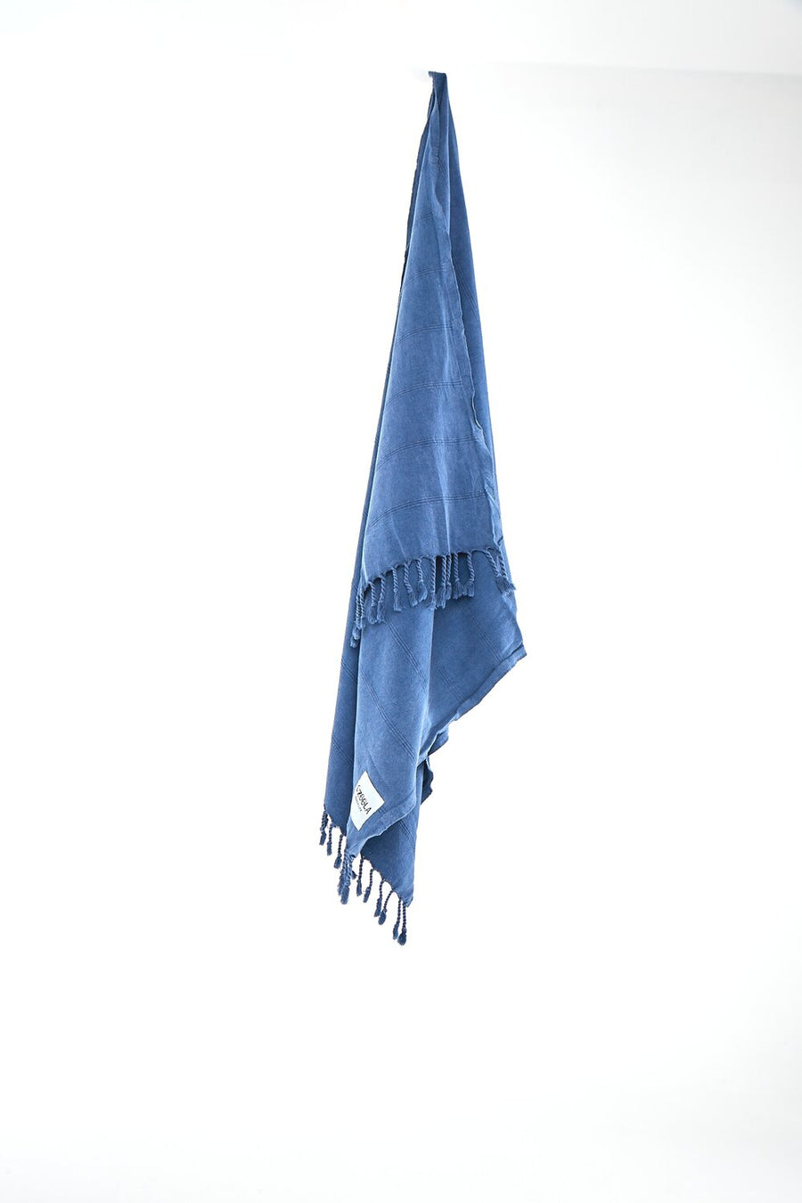 Ozoola Turkish beach towel in blue stonewash hanging