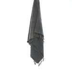 Ozoola Turkish beach towel in charcoal stonewash hanging