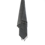 Ozoola Turkish beach towel in charcoal stonewash hanging