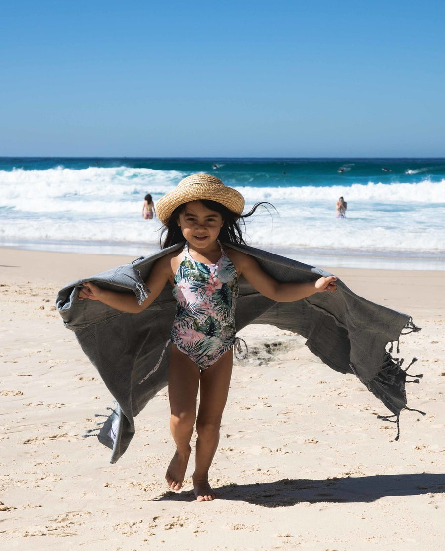 Child on beach with Ozoola Turkish beach towel